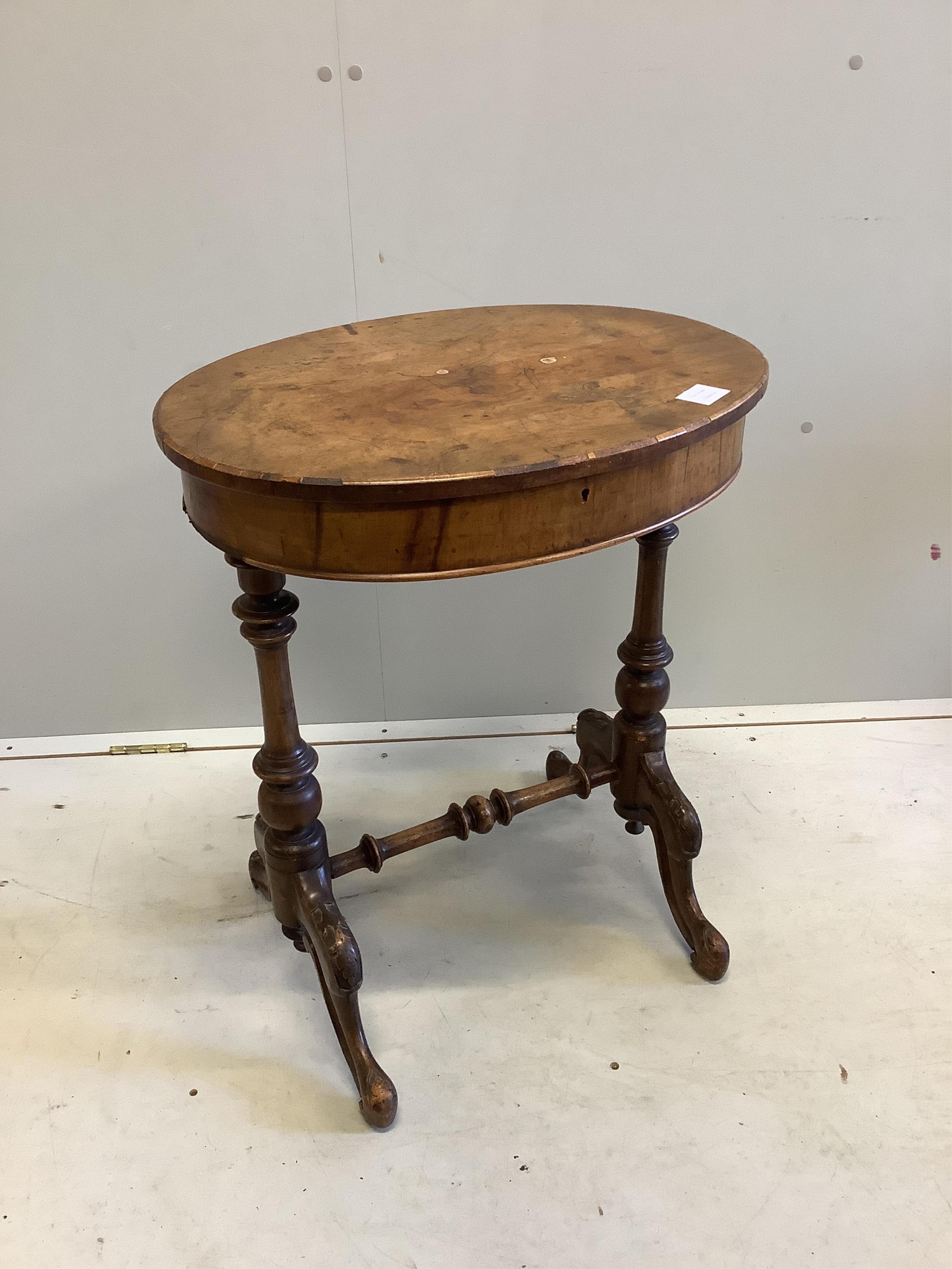 A Victorian oval walnut topped work table, width 56cm, depth 44cm, height 68cm. Condition - fair